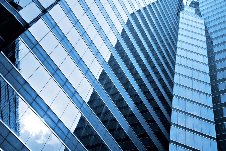 looking up at buildings made of laminated glass